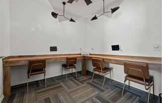 a long wooden table with chairs in a room