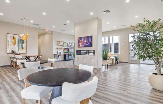 A modern dining room with a large table and chairs.