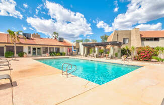 a swimming pool with a house in the background