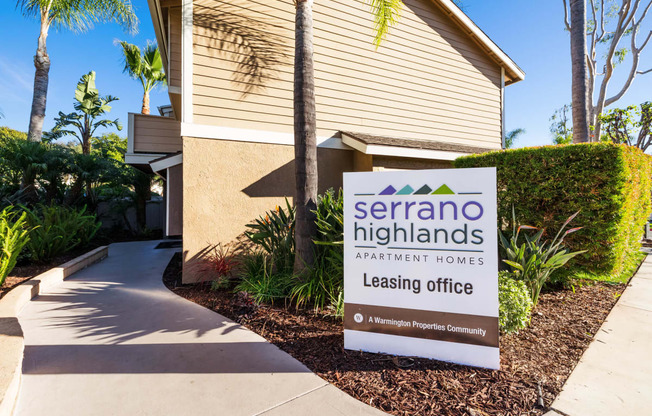 a leasing office sign in front of a building