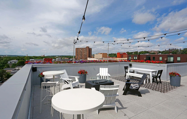 Stunning rooftop with string lights, casual dining area, and lounge seating.