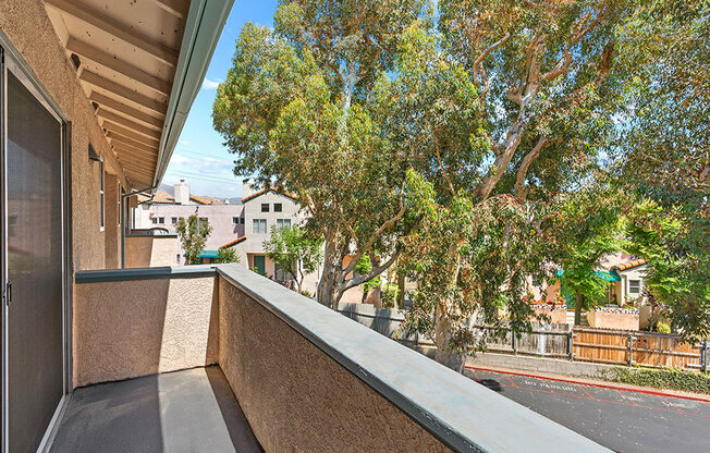 Private balcony with view of tree lined surrounding community.