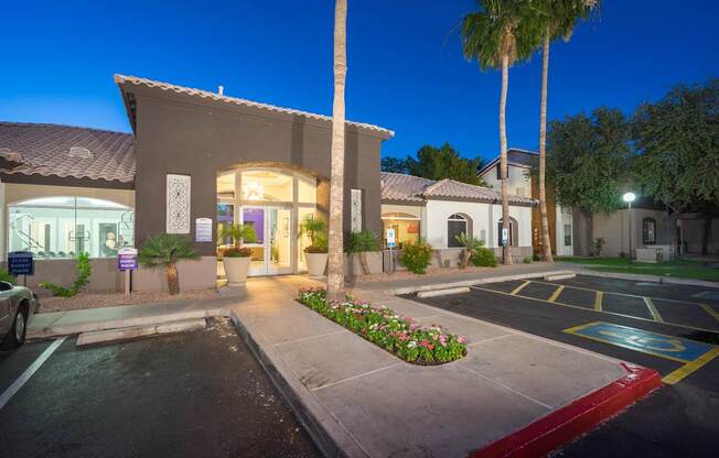 A building with a parking lot in front of it at night at Sterling Point Apartment Homes, Phoenix