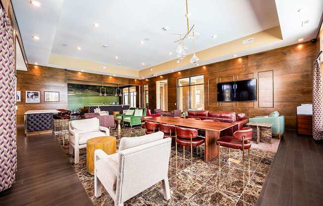A room with a long table surrounded by chairs.