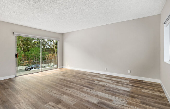 Hardwood floored bedroom with direct balcony access.