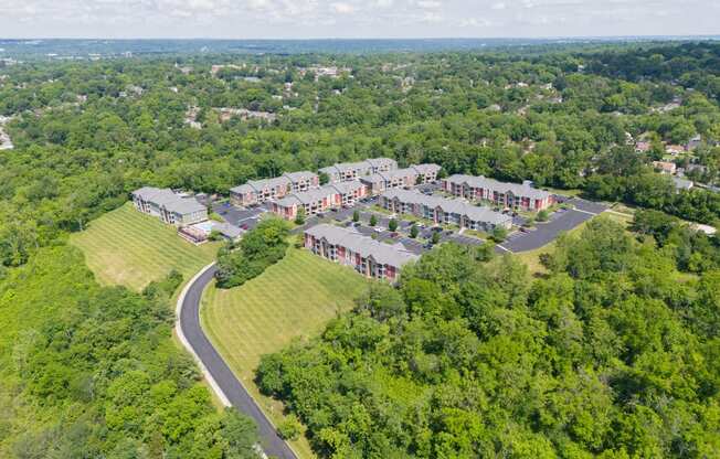 an aerial view of a group of houses next to a road