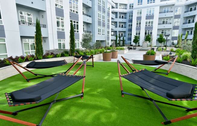 an image of the hammocks on the lawn of an apartment building