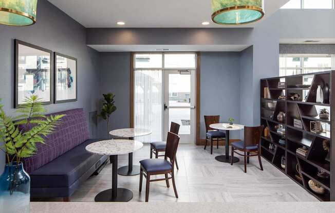A modern living room with a round table and chairs.
