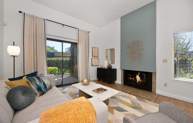 a living room with a couch coffee table and fireplace