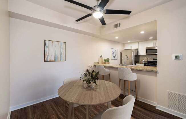 A dining area with a table and chairs.
