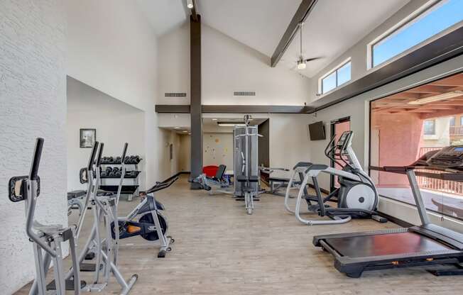 Gym with cardio equipment and weights at the Glen at Mesa Apartments, Mesa, Arizona 85201