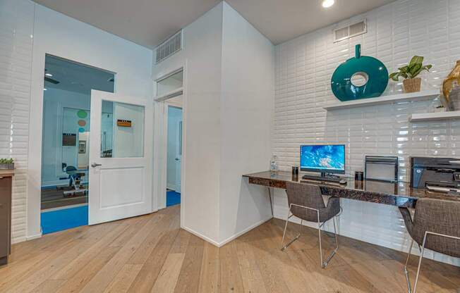 Study area with built in desk and chairs at Vue Live Oak Apartments, Texas