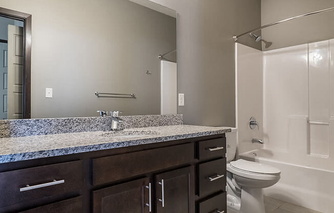 Large bathroom with granite countertops and a bathtub at North Pointe Villas