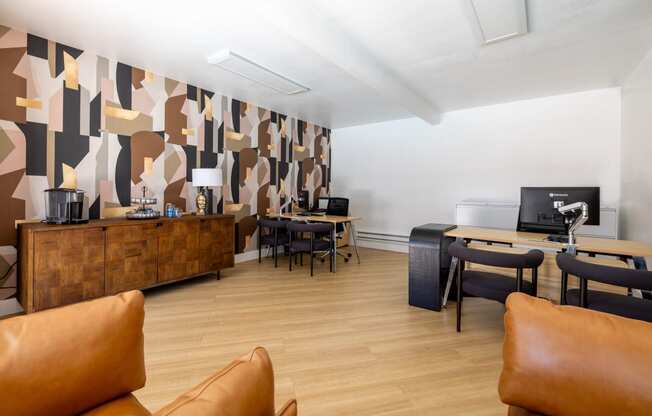 a living room with couches and chairs and a desk with a computer at Campbell West Apartments, Campbell, CA 95008