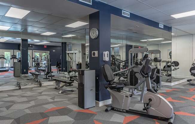 a gym with cardio machines and weights