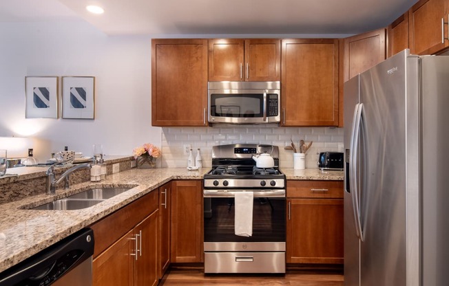 full kitchen with stainless steel appliances and granite counter tops