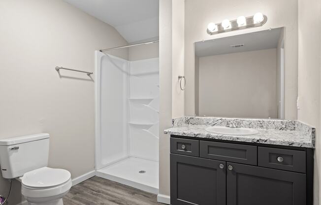 a bathroom with a toilet sink and shower and a mirror at Diamond Ridge Townhomes, Oklahoma City, 73114