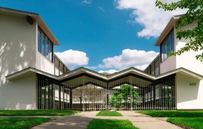 a rendering of a building with glass windows and a courtyard