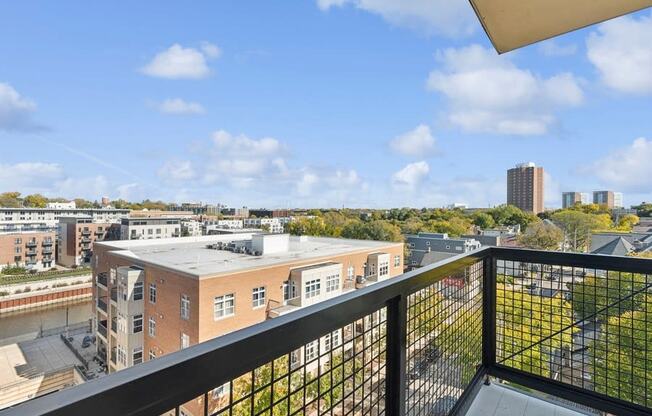 the view of the city from the balcony of an apartment building