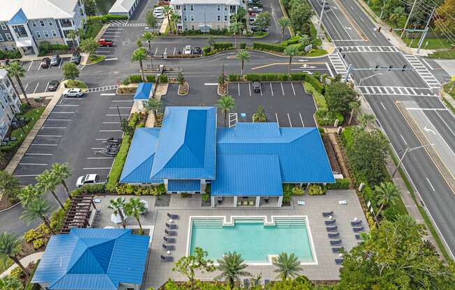 an aerial view of a building with blue roofs