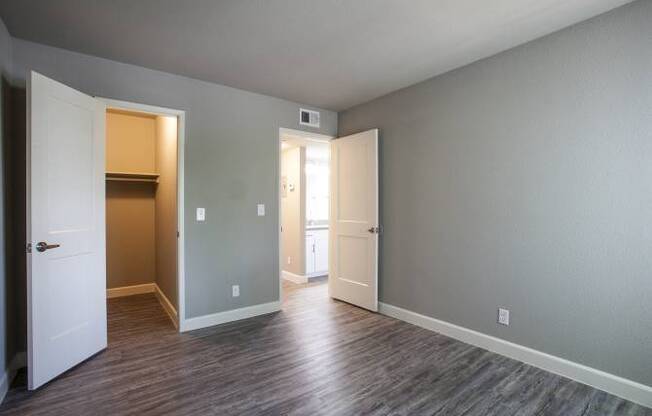 A room with a white door and a brown door.
