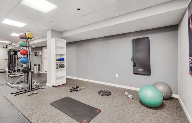 Gym room with variety of equipment, weight rack and exercise balls at Columbia Pointe, Columbia, MD, Maryland