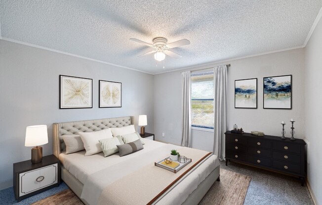 A bedroom with a large bed, a dresser, and a ceiling fan.