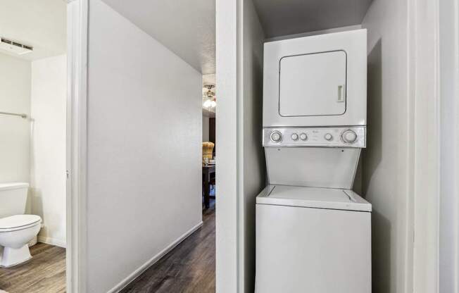 A white toilet with a tank built into a wall.