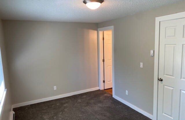 a bedroom with gray walls and a white door