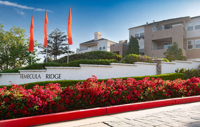 A sign that says Temecula Ridge in front of a building.