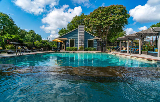 a swimming pool with a house in the background