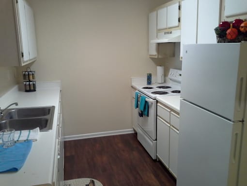 a kitchen with white appliances and white cabinets