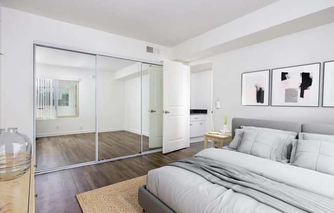 a bedroom with a large bed and a glass closet