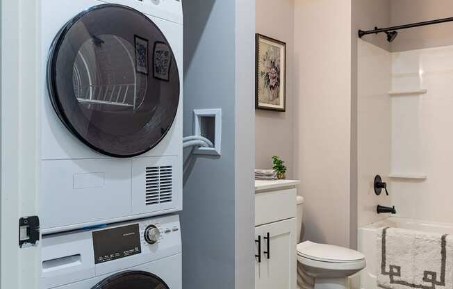 A white washer and dryer in a small laundry room.