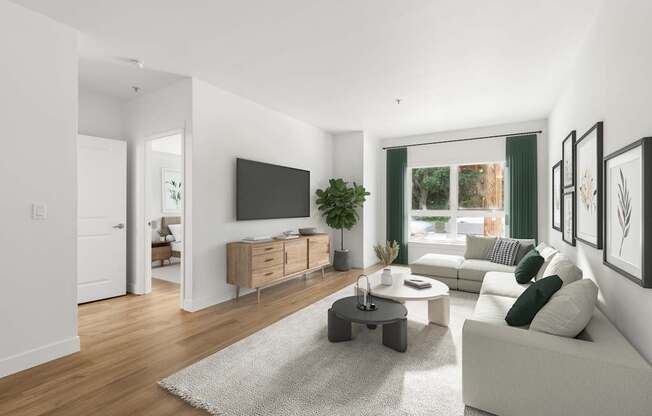 A modern living room with a white couch, a grey rug, and a wooden floor.
