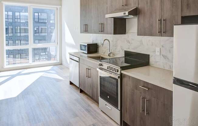 A kitchen with a stove top oven and a microwave.