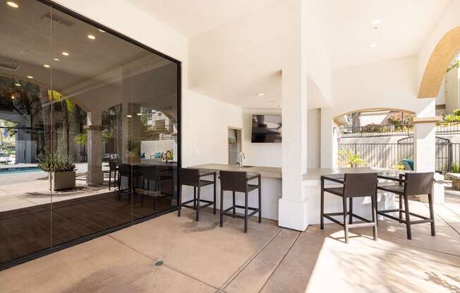 A patio with a table and chairs is visible through a glass door.