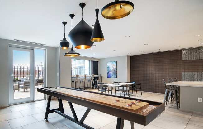 a pool table in a room with tables and chairs and a bar