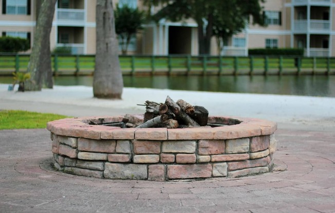 a fire pit in front of an apartment complex