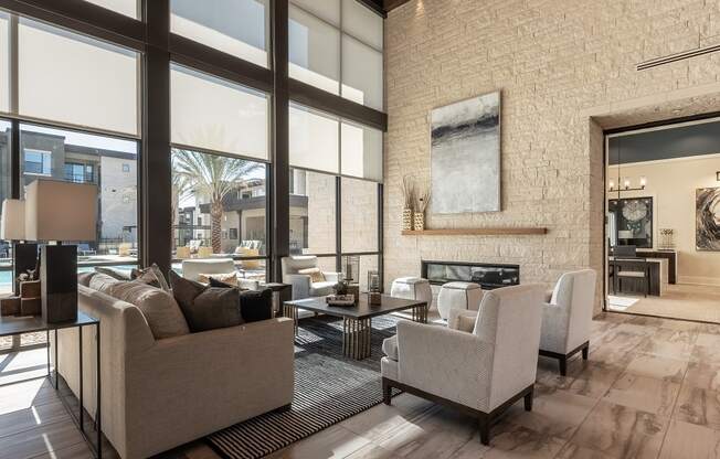 A living room with a couch, chairs, and a fireplace.