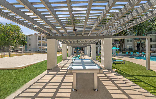 Outdoor Ping Pong Table and Pool Area at Essence Apartments in Dallas, TX.