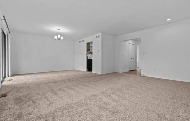 an empty living room with white walls and carpet at Edge At Farmington Hills - Farmington Hills, MI, Farmington Hills