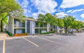 A parking lot in front of a building with trees. at Canvas, Austin, Texas