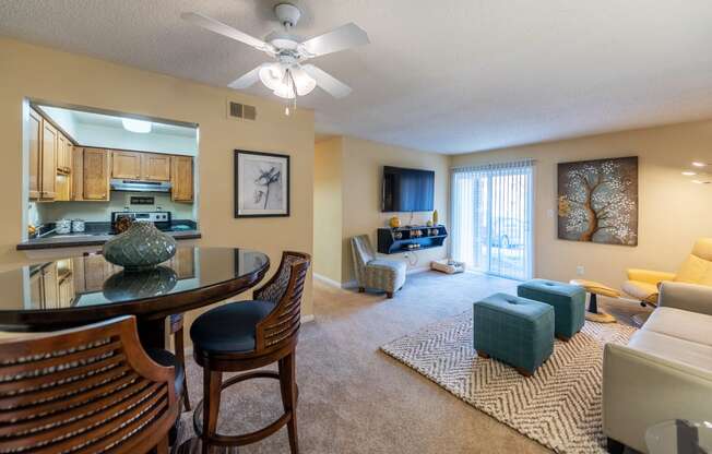 a living room with a kitchen and a dining table