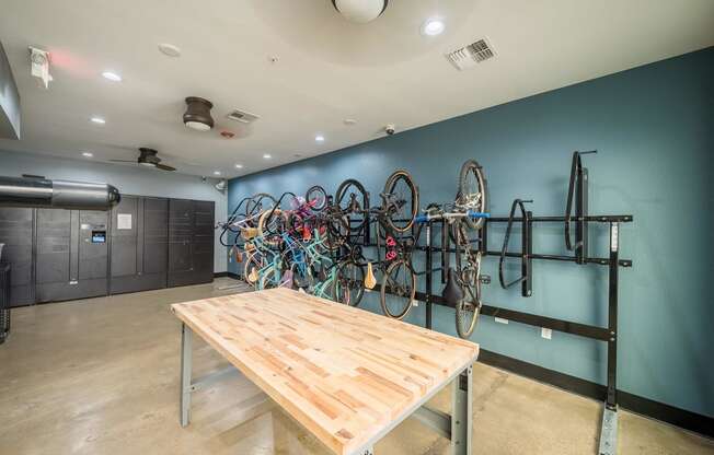 a room with a table and bikes on the wall