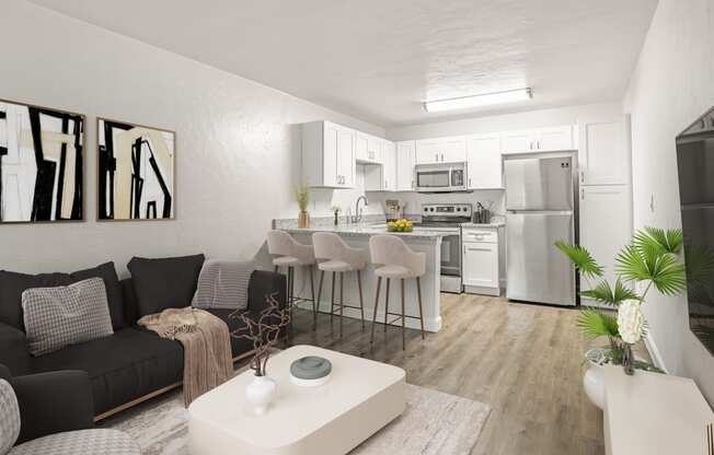 a living room with a kitchen in the background and a large white coffee table in the foreground