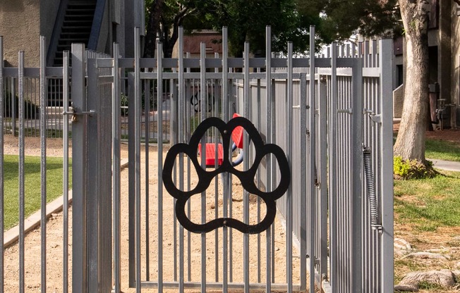 a gate with a olympic symbol on it in front of a fence