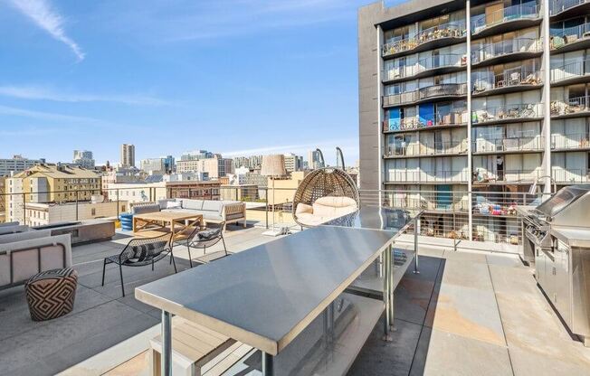 Outdoor kitchen space with BBQ grills at TL Residences