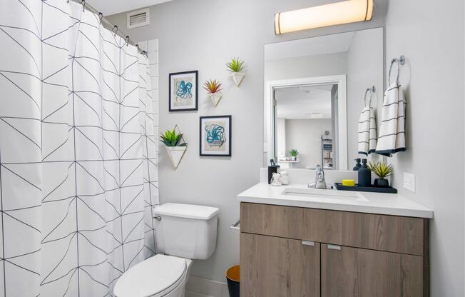 a bathroom with a shower and a toilet and a sink