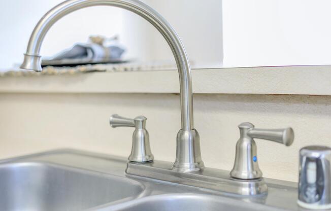 a kitchen with a sink and a mirror